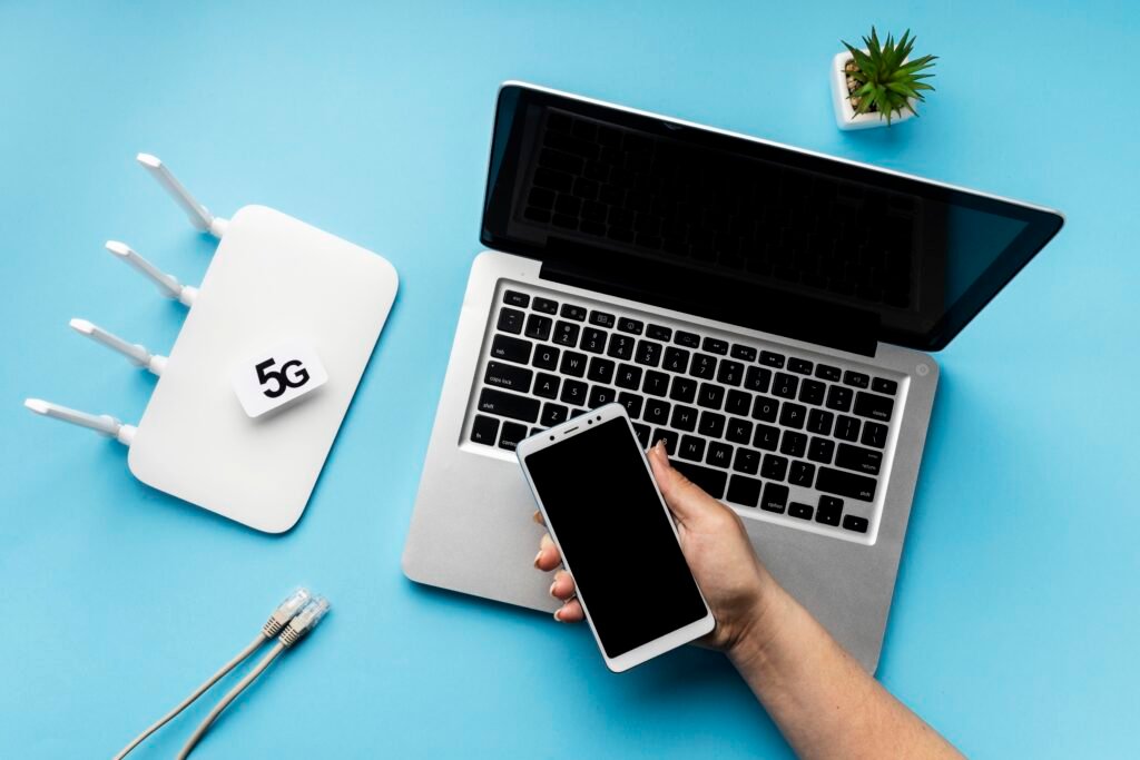 top-view-wi-fi-router-with-laptop-hand-holding-smartphone - Kanineetech System Solutions